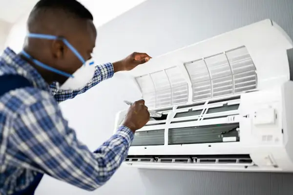 HVAC technician repairing air conditioner system