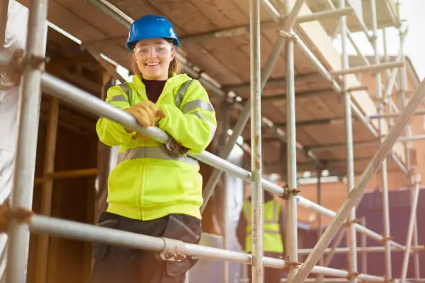 Construction scaffolding worker at building site